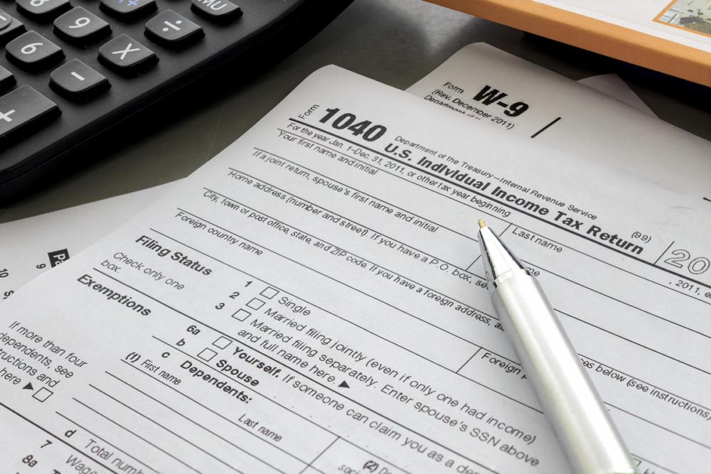 tax forms, calculator, pen, strategic tax resolution